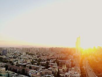 Buildings in city at sunset