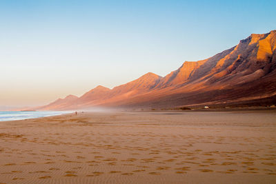 Scenic view of beach against clear sky