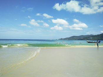 View of beach against cloudy sky