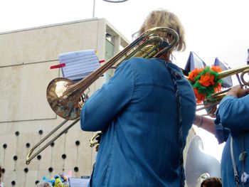 Rear view of woman playing trumpet