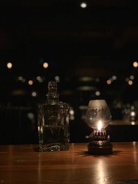 Close-up of illuminated lamp on bar counter