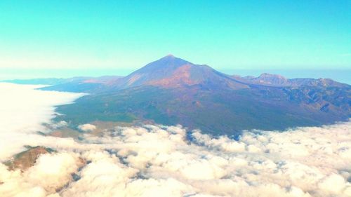 Scenic view of mountains against cloudy sky