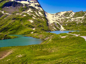 Scenic view of lake and mountains against sky