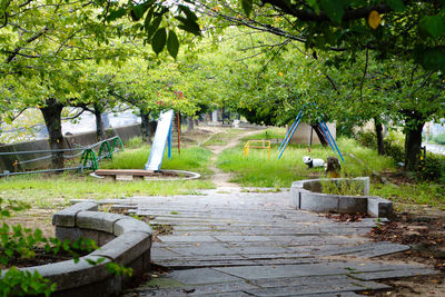 Built structure by trees against plants