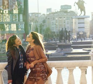 People on city street with buildings in background