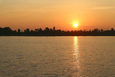 Scenic view of lake against romantic sky at sunset