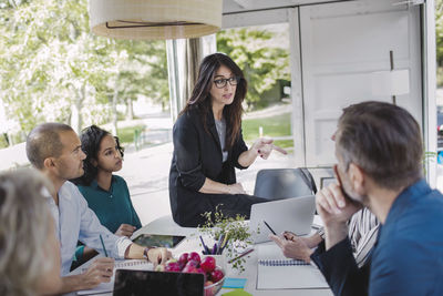 Businesswoman discussing strategy with colleagues in portable office truck