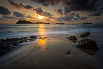 Scenic view of sea against sky at sunset