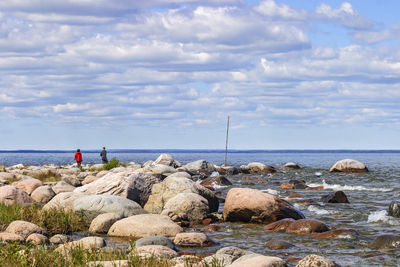 Panoramic view of rocks on beach against sky