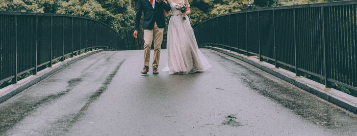 Rear view of woman walking on railway bridge