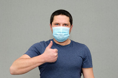 Portrait of man standing against white background