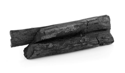 Close-up of broken wood against white background