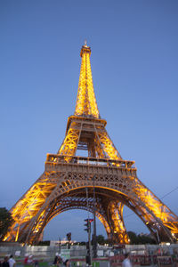 Low angle view of illuminated tower against sky