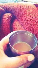 Close-up of hand holding tea cup