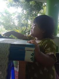 Side view of girl looking at book