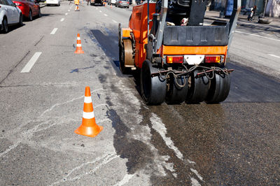 High angle view of construction vehicle by traffic cones on street