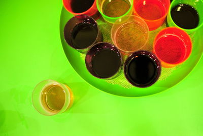Directly above shots of drinks in plate on green table