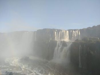 Scenic view of waterfall against clear sky