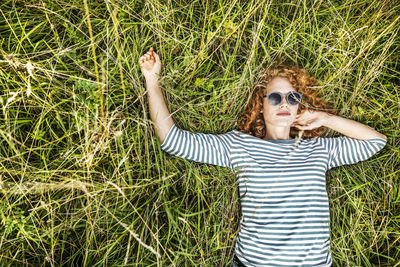 Portrait of young woman relaxing on a meadow