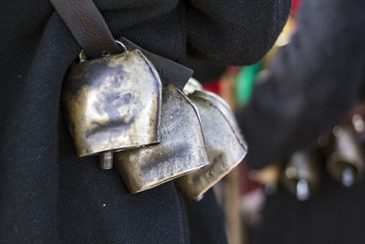 Close-up of person holding camera on metal