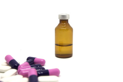 Close-up of glass bottle against white background