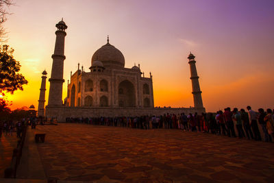 Tourists at taj mahal during sunset