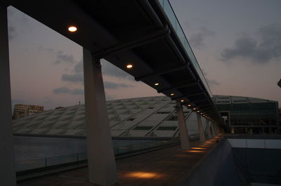 Illuminated bridge against sky at night