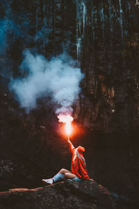 Man and woman in illuminated forest at night