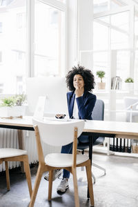 Young businesswoman sitting at her desk