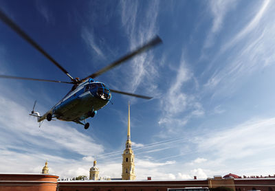 Low angle view of helicopter flying against sky