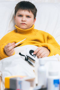 Portrait of boy lying on bed