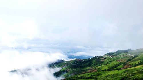 Idyllic shot of mountain in foggy weather against sky