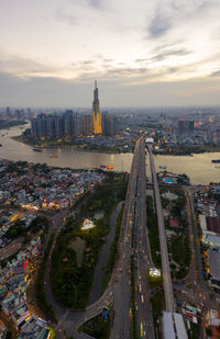 High angle view of illuminated street amidst buildings in city