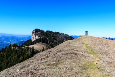 Scenic view of mountains against clear blue sky