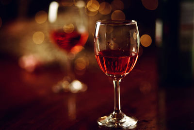 Close-up of wine glasses on table