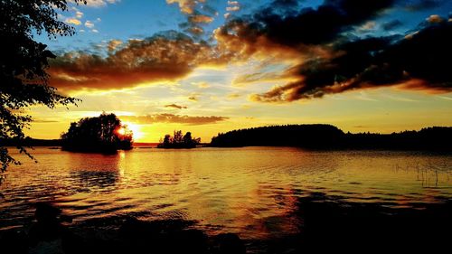 Scenic view of lake against romantic sky at sunset