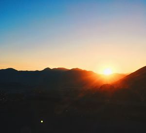 Scenic view of silhouette mountains against sky during sunset