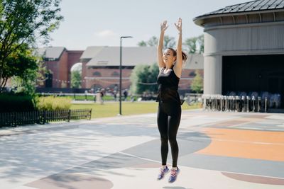 Full length of woman standing in front of building