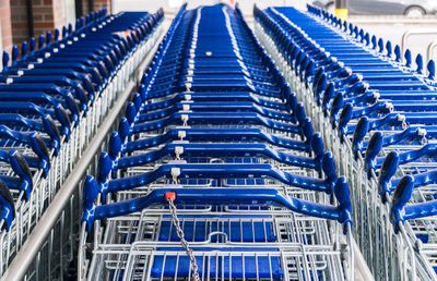 Blue shopping cart arranged in row