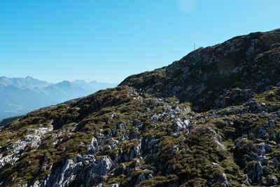 Scenic view of mountains against clear blue sky