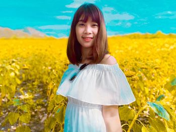 Portrait of young woman standing against plants