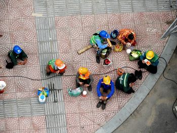 Directly above shot of workers sitting on walkway