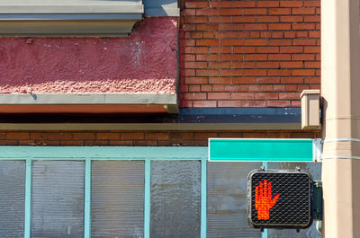 Stop signal on metallic pole against building in city