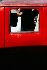 Close-up of hand on window