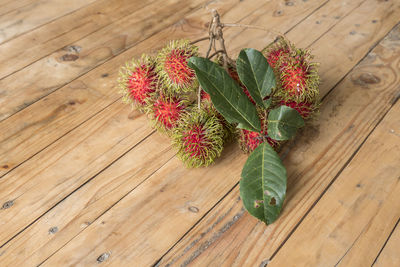 High angle view of fresh flowers on hardwood floor