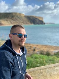 Man wearing sunglasses while standing outdoors