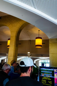 Rear view of people standing in corridor