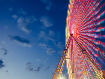 Blurred motion of illuminated ferries wheel at night