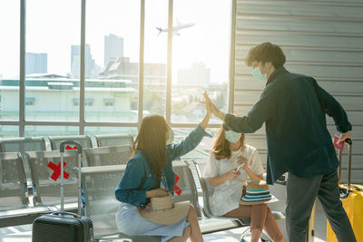 People sitting by glass window