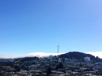 View of cityscape against blue sky